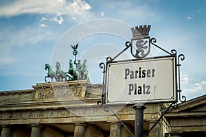 Pariser Platz street sign in Berlin, Germany with Brandenburg gate behind