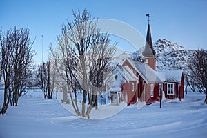 The parish church in Flakstad in winter covered with snow, near Ramberg Lofoten, Norway photo