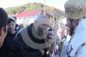 Parishioner kissing the cross