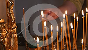 The parishioner put a candle inside an Orthodox church