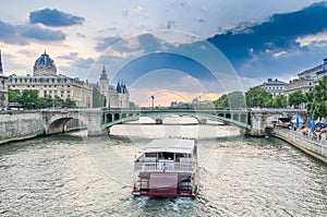 Parisian bateau on the Seine river at sunset