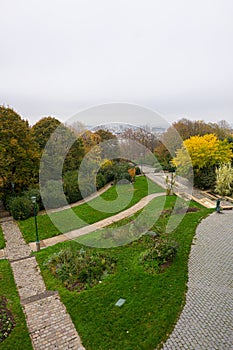 Parisian park on a cloudy day with the city visible in the backgriound photo