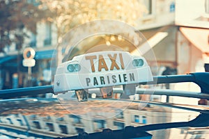 Parisian taxi with car reflection.
