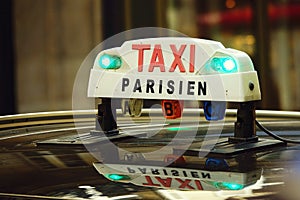 Parisian taxi sign on the roof of a car in the french capital photo