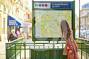 Parisian woman near the subway plan