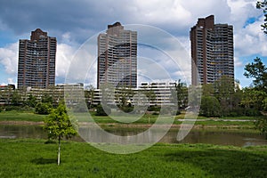 Park adjacent to urban skyscrapers along a riverbank, Manheim, Germany