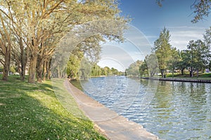 Park along river and green trees. Beautiful landscape