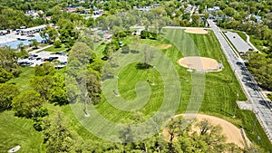 Park baseball kickball fields kids playground aerial mown fields with mower tracks neighborhoods