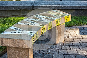 Park bench banned with precautionary tape due to COVID-19 contingency