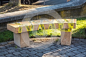 Park bench banned with precautionary tape due to COVID-19 contingency