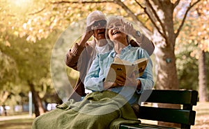 Park, bench and binoculars with a senior couple birdwatching together outdoor in nature during summer. Spring, love and