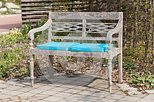 Park bench with blue seat cushions