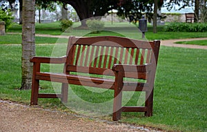 Park bench brown with backrest english type beige path thresh lawns wet rain rainy threshing