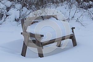 Park Bench Covered in Snow in Gardiners Park, NY