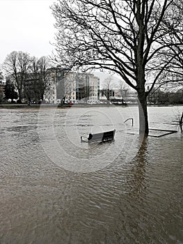 Park bench in the flooded River Ouse in York, England