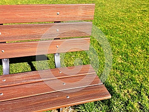 Park Bench and Green Grass with Shadow