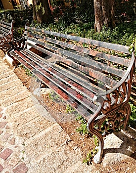 Park bench at san miguel de allende rusted color texture under black deteriorated paint