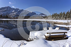 Park Bench and Snowy Lake in Alberta Foothills of Canadian Rockies