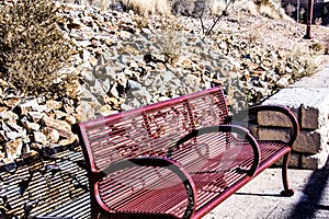 Park Bench with a stoney desert hillside