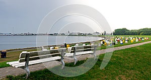 Park bench on top of a dike at the beach of Cuxhaven, Germany