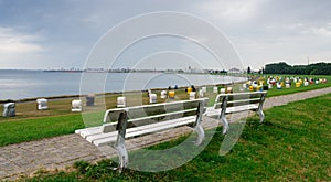 Park bench on top of a dike at the beach of Cuxhaven, Germany