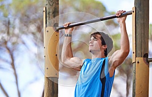 Park, fitness and man on pull up bar with exercise for morning training, health and muscle building in San Francisco