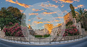 Park with flowers decorations, at city walls fortifications. Liberty Gate, Rhodes old town, Greece