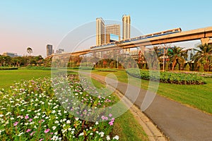 A park full of flowers With electric trains