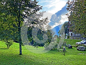 A park with a garden and green areas next to the Grand Hotel Giessbach above Lake Brienz Brienzersee - Canton of Bern