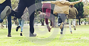 Park, grass field and back of friends running, having fun and excited for outdoor wellness, freedom or fresh Spring air