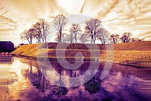 Park and lake near the Kastellet fortress. Copenhagen, Denmark. Orange and purple toned