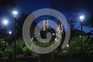 Park at main square `Francisco Canton Rosado` with towers of the church San Servacio at night in the downtown of Valladolid, photo