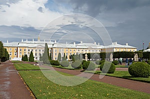 Park in Peterhof, with a green lawn and a palace in front, a landmark, showplace in St. Petersburg photo