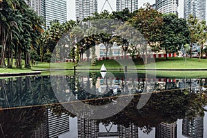 Park and pool under Petronas twin towers in Kuala Lumpur, Malaysia