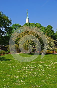 A Park in Riga during Summer Time with the tall Freedom Monument at the back