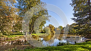 Park with scenic pond in the autumn