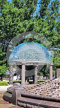 At a park sculpture with trees in the background