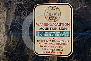 Park sign warning hikers about mountain lions photo