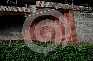 Park staircase on the terrace of an Italian garden. the stairs are made of red bricks glued to cement. forged metal railing on the