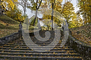 Park stairs with stone statues in autumn. Cesis, Latvia