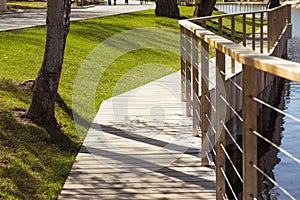 Park in summer. wooden lakeside promenade, a place for outdoor recreation