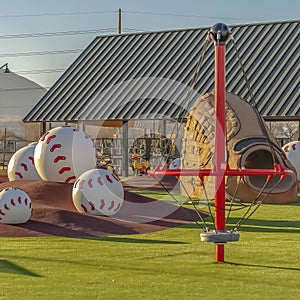 Park with a variety of playground equipment and structures viewed on a sunny day