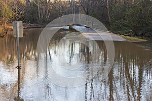 Park Walkway And Greenspace Area Partially Submerged By Creek Flooding