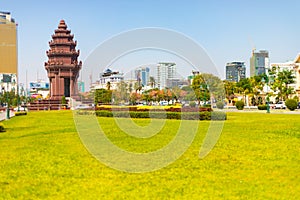 Park with well manicured lawn and the Independence monument in the background in Phnom Penh Cambodia