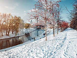 Park in Yekaterinburg city along the Iset river at winter time at sunny day with people walking