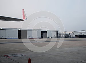 Parked aircraft near the hangar. Cargo plane on the airfield. Commercial air freight. Sunset spotting at the airport. photo