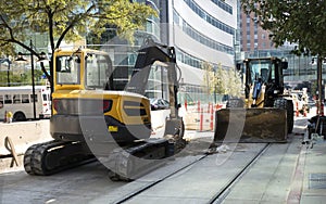 Parked backhoe and front end loader construction equipment