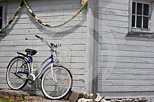 Parked bicycle beside boathouse