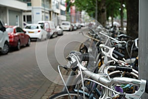 Parked bicycles along the street in Rotterdam, Netherlands.