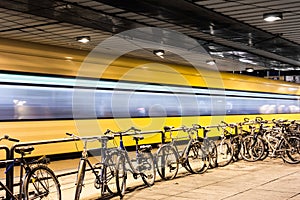 Parked bicycles and in the background a moving t